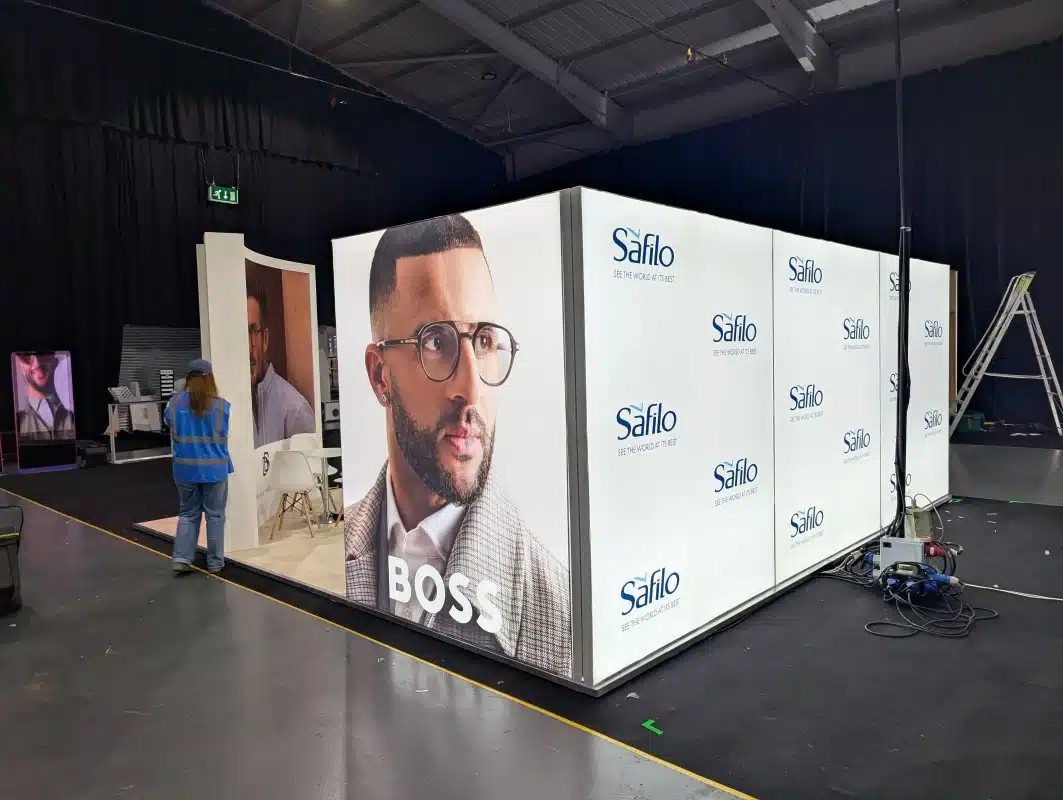 exhibition stand showing bright freestanding lighboxes, with large lifestyle images at event